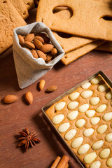 Close-up on almonds and gingerbread cottage elements