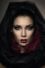Fototapeta na wymiar close-up portrait of woman in black hood