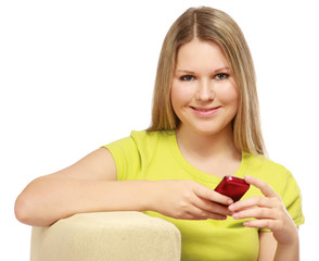 A young woman sitting on the chair with a mobile phone