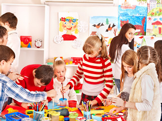 Child painting at art school.