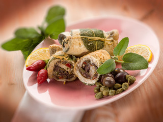 swordfish stuffed with capers olives and sage, selective focus