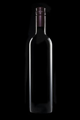 Bottle of red wine on black background