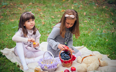 Happy little girlfriends in park