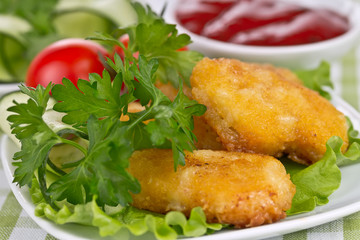 appetizing chicken nuggets with lettuce leaves