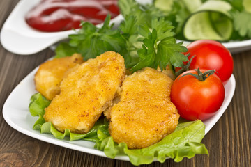 appetizing chicken nuggets with lettuce leaves