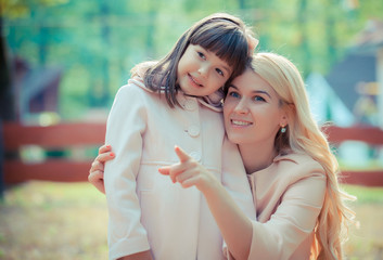 Fototapeta premium happy young mother with the daughter in park