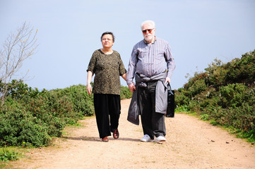 lovely senior couple walking on a path