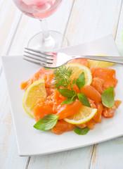 fresh salmon with lemon on the white plate
