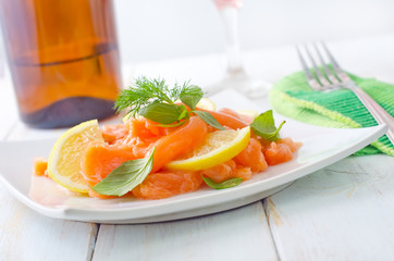 fresh salmon with lemon on the white plate