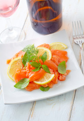 fresh salmon with lemon on the white plate