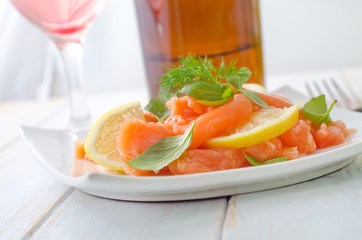 fresh salmon with lemon on the white plate