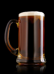 Mug of beer over black background