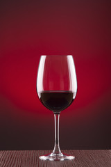 Copa de vino sobre fondo rojo