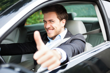 Portrait of an happy man on his car