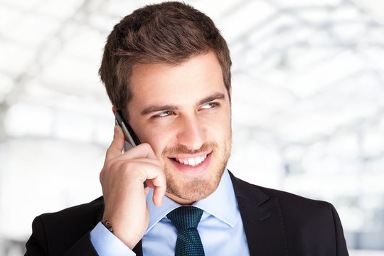 Handsome businessman talking on the phone