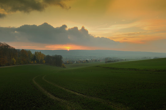 Misty sunset,golden sunbeam shine through the Deister.