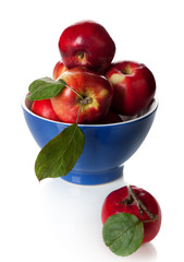Red apples in a bowl on a white background
