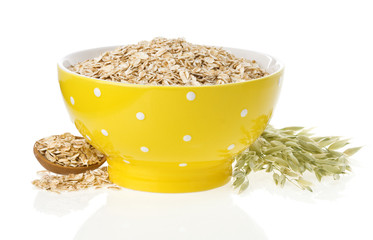 oat flake in bowl and ears on white