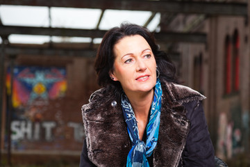 Urban fashion portrait of pretty woman with black hair.