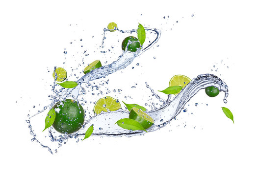 Fresh limes in water splash, isolated on white background