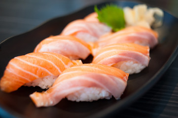 Close up of Salmon Sushi Set on Black Dish