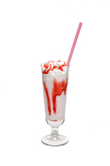 Milkshake with strawberry syrup in glass cup