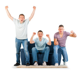 Young men sitting on a sofa cheering, on white background