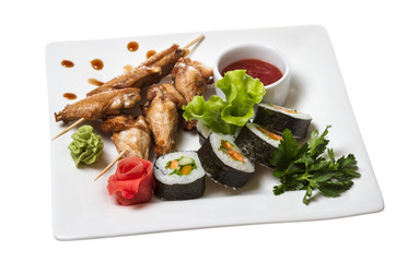 Buffalo chicken wings on plate with sushi