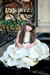 portrait of little girl outdoors in Princess dress