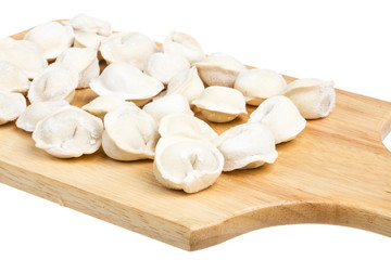 Some raw dumplings on the wooden board