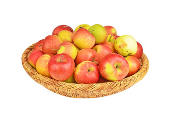 Red apple in a wattled basket, isolated on white background