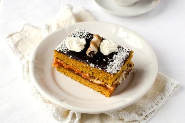 Sponge-cake with apricot jam in chocolate