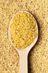 bulgur wheat in wooden spoon