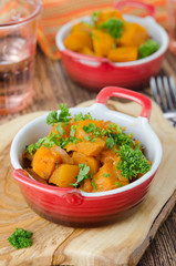 pumpkin baked in a tomato sauce with garlic and herbs closeup tw