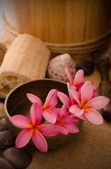 tropical spa setup with frangipani flower