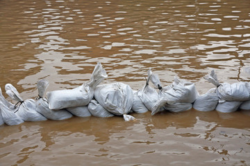 wall of sandbags to fend off raging river