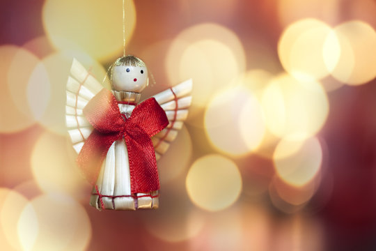christmas theme with angel decoration on red and gold background