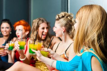 Frauen in einem Club oder einer Disco mit Cocktails