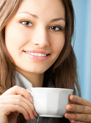 Cheerful smiling business woman with coffee