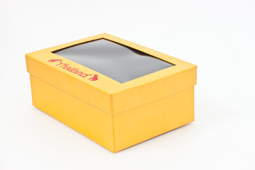 yellow gift box on white paper
