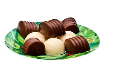 Chocolates on a plate, isolated on a white background