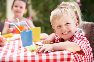 Group Of Children Enjoying Outdoor Tea Party