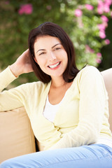 Woman Relaxing On Sofa At Home