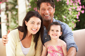 Family Sitting On Sofa Together