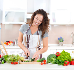 Young Woman Cooking. Healthy Food - Vegetable Salad