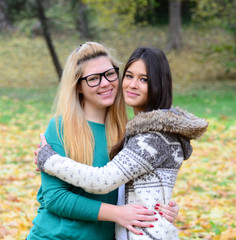 Two happy girl friends in posing in nature