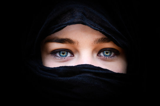 Portrait of beautiful woman with blue eyes wearing black scarf