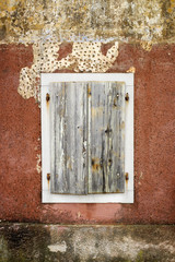 Cloesed woodn window with white border