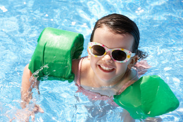 Portrait Of Girl With Armbands In Swimming Pool