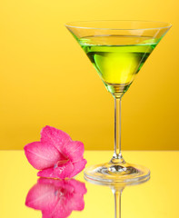 glass with cocktail and gladiolus bud